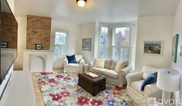 Portland apartment for rent - A living room with a floral rug and white furniture.