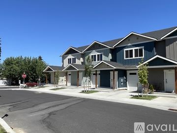 Wenatchee apartment for rent - A kitchen with white cabinets and a black stove top.