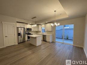Wenatchee apartment for rent - A spacious kitchen with a refrigerator, oven, and microwave.