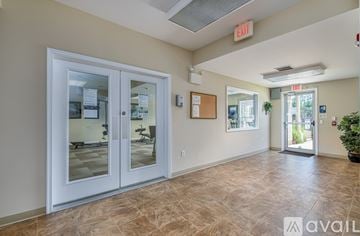 Mountville apartment for rent - A room with a tiled floor and a glass door leading to another room.