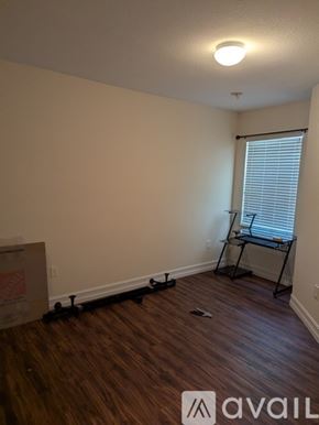 Miramar townhouse for rent - A room with wooden flooring and a window with blinds.