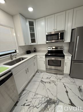 Rotonda West apartment for rent - A bed with a grey comforter and a white headboard.