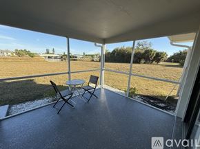 Rotonda West apartment for rent - A patio with a table and chairs overlooking a grassy field.