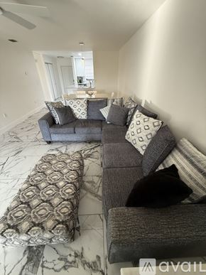Rotonda West apartment for rent - A bedroom with a bed, a ceiling fan, and a marble floor.