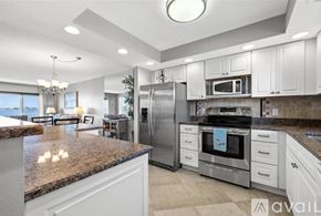 St. Petersburg condo for rent - A kitchen with granite countertops and stainless steel appliances.