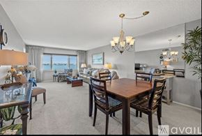 St. Petersburg condo for rent - A dining room with a wooden table and chairs.