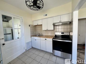 West Windsor Township house for rent - A kitchen with white cabinets and a black stove top oven.