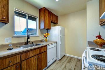 Fairfield apartment for rent - A kitchen with wooden cabinets and a white refrigerator.