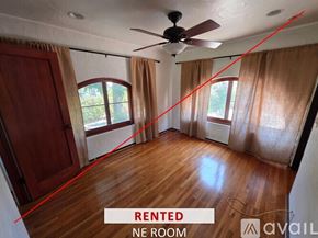 Upland house for rent - A spacious room with a stone fireplace and a wooden ceiling.