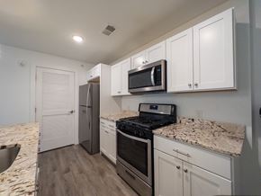 Mt. Laurel apartment for rent - A kitchen with a white countertop and a bar stool.