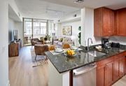 Alexandria apartment for rent - A kitchen with brown cabinets and black appliances.