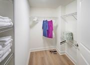 Alexandria apartment for rent - A bedroom with a bed, nightstand, and a closet with hangers.