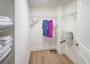 Alexandria apartment for rent - A bedroom with a bed, nightstand, and a closet with hangers.