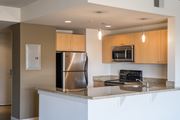 Washington apartment for rent - A modern kitchen with a stainless steel refrigerator and microwave above the stove.