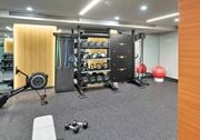Washington apartment for rent - A gym with a variety of equipment including weights and a bench.