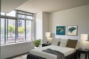 Washington apartment for rent - A bedroom with a large bed and two lamps.