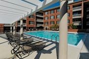 Arlington apartment for rent - A pool with chairs and a building in the background.