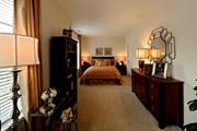 Arlington apartment for rent - A bedroom with a bed, dresser, and lamp.