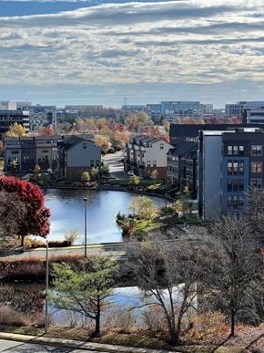 Herndon apartment for rent - A view of a lake surrounded by buildings and trees.