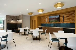 Fairfax apartment for rent - A modern dining room with white tables and chairs.