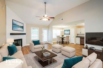 Clarksville house for rent - A living room with a fireplace and a painting on the wall.