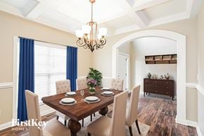 Clarksville house for rent - A dining room with a wooden table and chairs.