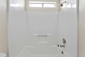 Burbank apartment for rent - A white bathroom with a window above the tub.
