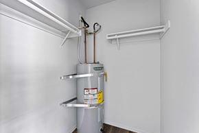 Burbank apartment for rent - A white wall with a metal pipe and a yellow tag on it.