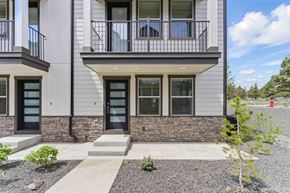 Bend apartment for rent - A modern two-story building with a balcony on the second floor.