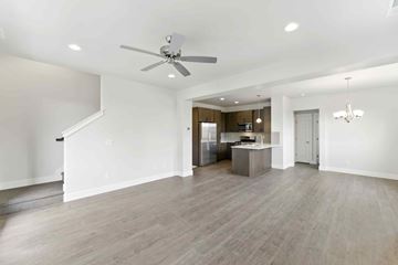 Bend apartment for rent - A spacious living room with a kitchen in the background.
