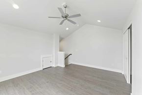 Bend apartment for rent - A room with a ceiling fan and light fixture, and a door on the right.