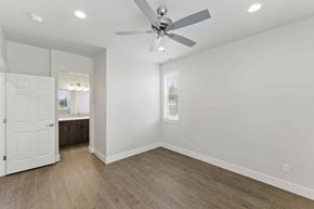 Bend apartment for rent - A room with a ceiling fan and wooden flooring.