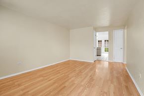 Lakewood apartment for rent - A room with wooden flooring and white walls.