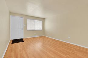 Lakewood apartment for rent - A room with a white door and a window with blinds.