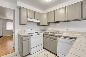 Lakewood apartment for rent - A kitchen with a white stove top oven and a white dishwasher.