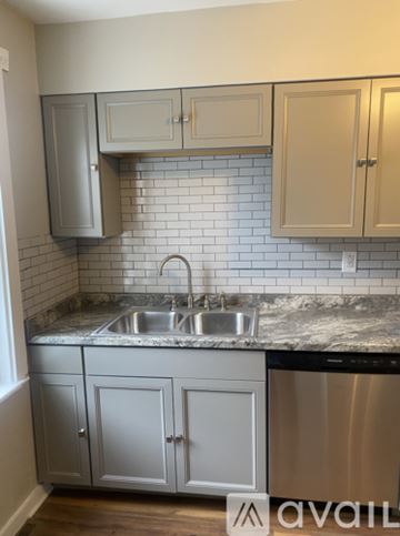 Monaca house for rent - A kitchen with a stainless steel dishwasher and a marble countertop.