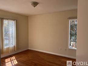 Los Angeles apartment for rent - A room with wooden floors and two windows.