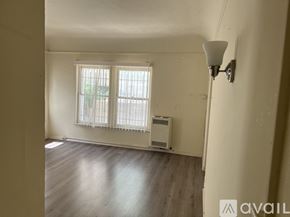 Los Angeles apartment for rent - A room with a window and a lamp on the wall.