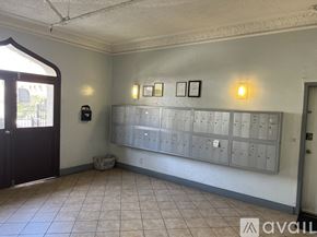 Los Angeles apartment for rent - A room with a wall of mailboxes and two wall-mounted lights.
