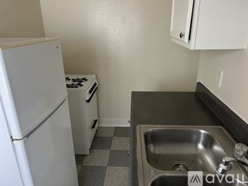 Los Angeles apartment for rent - A small kitchen with a white fridge, a stove, and a sink.