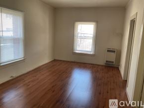 Los Angeles apartment for rent - A room with wooden flooring and a window with blinds.