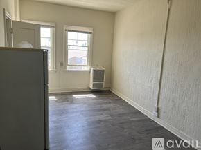 Los Angeles apartment for rent - A room with a grey floor and white walls, with a window and a radiator.