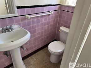Los Angeles apartment for rent - A white sink is on the left of a toilet in a pink tiled bathroom.
