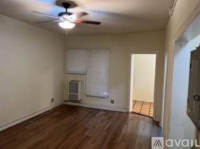 Los Angeles apartment for rent - A room with a ceiling fan and a window with blinds.
