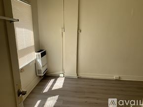 Los Angeles apartment for rent - A room with a radiator and a wall-mounted heater.