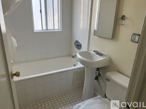 Los Angeles apartment for rent - A white bathroom with a sink, toilet, and bathtub.