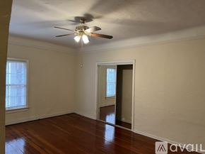 Los Angeles apartment for rent - A room with a ceiling fan and wooden floors.