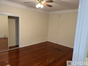 Los Angeles apartment for rent - A room with wooden floors and a ceiling fan.