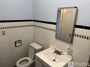 Los Angeles apartment for rent - A bathroom with a toilet, sink and mirror.