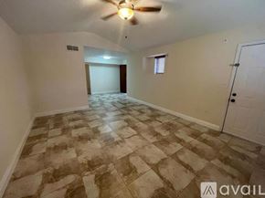 Miami apartment for rent - A room with a ceiling fan and tiled flooring.